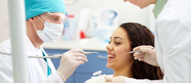 A dentist examining a patient.