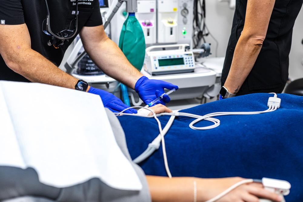 Anesthesia team placing an IV line for a sedated patient