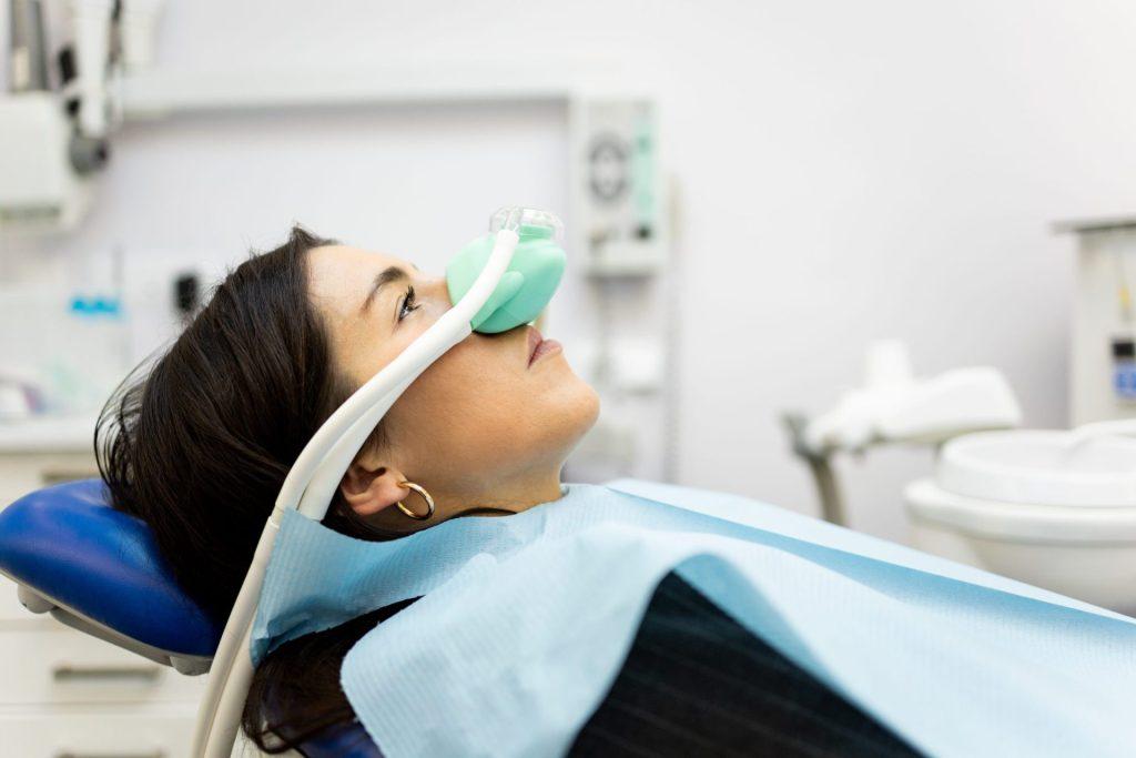 Relaxed patient breathing nitrous oxide through a nose mask