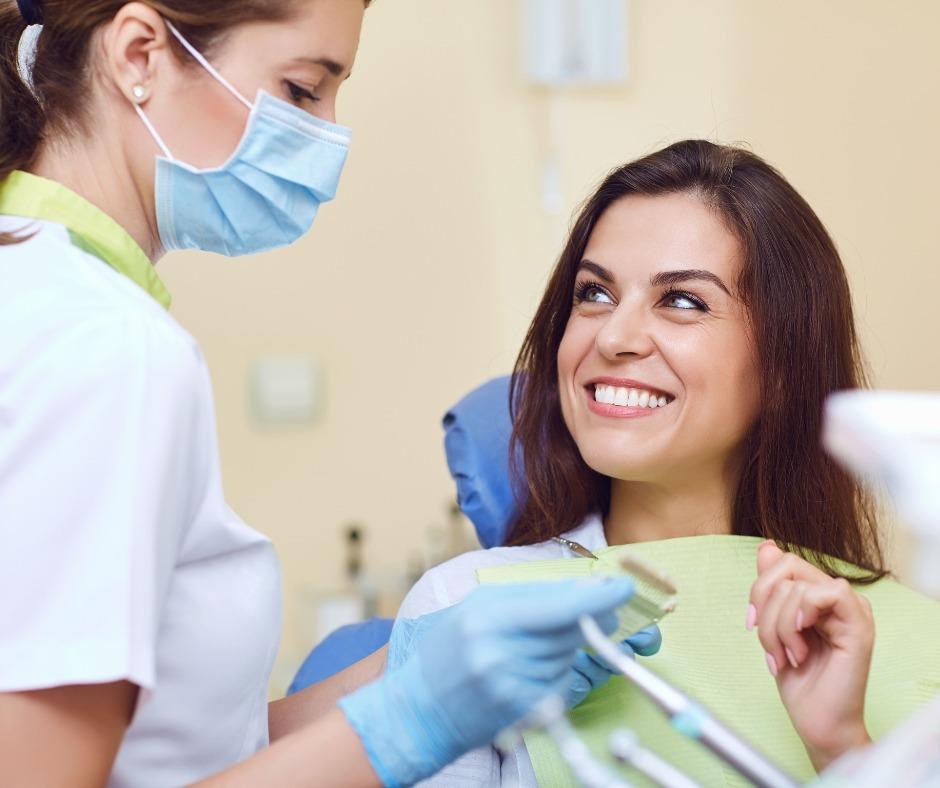 Smiling patient talking with a dental hygienist