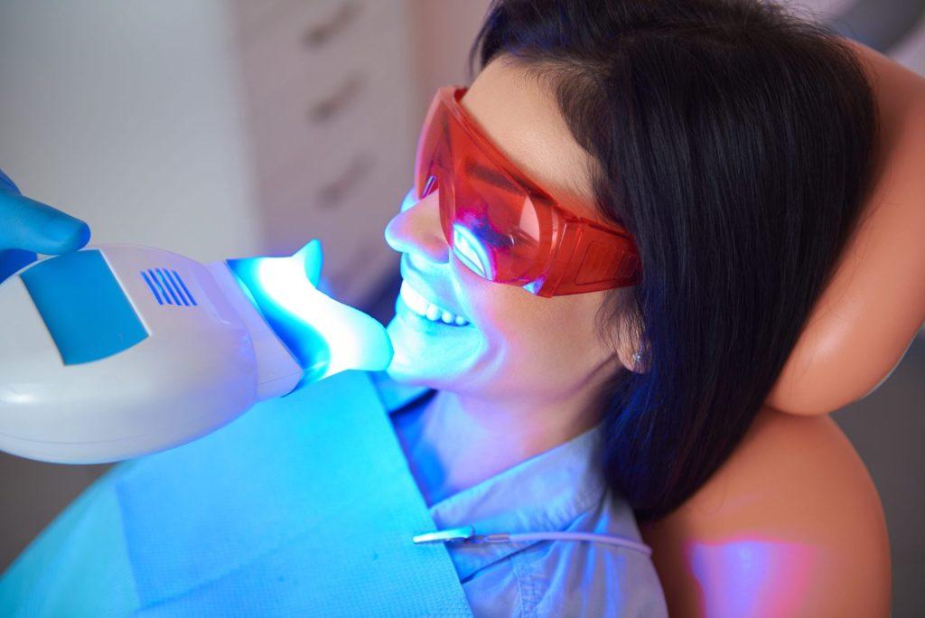 Patient wearing protective glasses during in-office teeth whitening